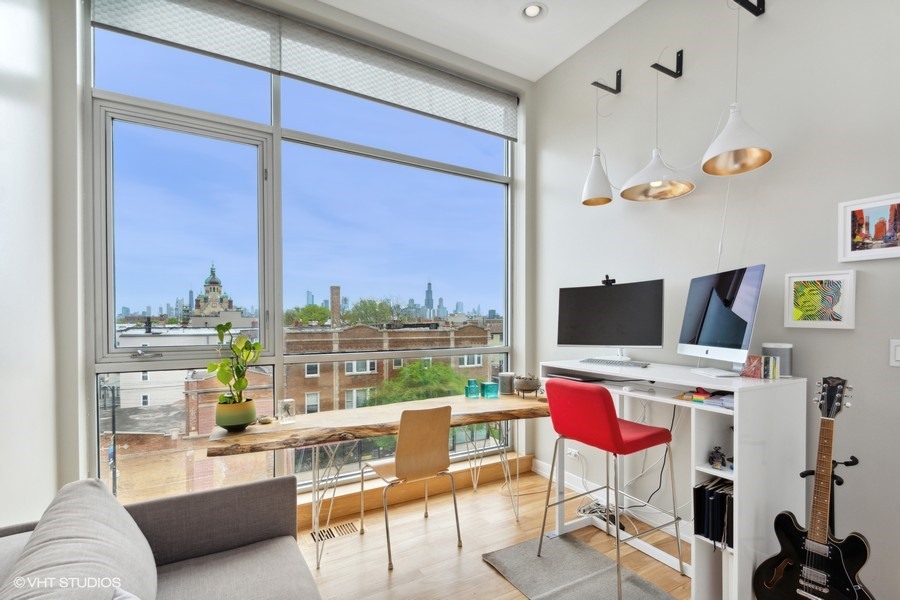 2408 West Rice Street, Unit 403 Chicago, IL 60622 - Photo 14 of 19 a living room with a couch and a flat screen tv