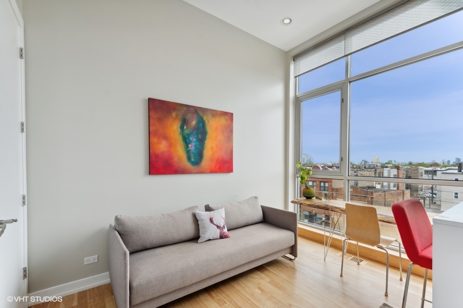 2408 West Rice Street, Unit 403 Chicago, IL 60622 - Photo 15 of 19 a living room with furniture a rug and a floor to ceiling window