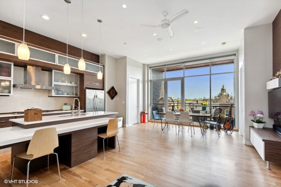 2408 West Rice Street, Unit 403 Chicago, IL 60622 - Photo 3 of 19 a dining hall with stainless steel appliances kitchen island granite countertop a dining table chairs and view living room
