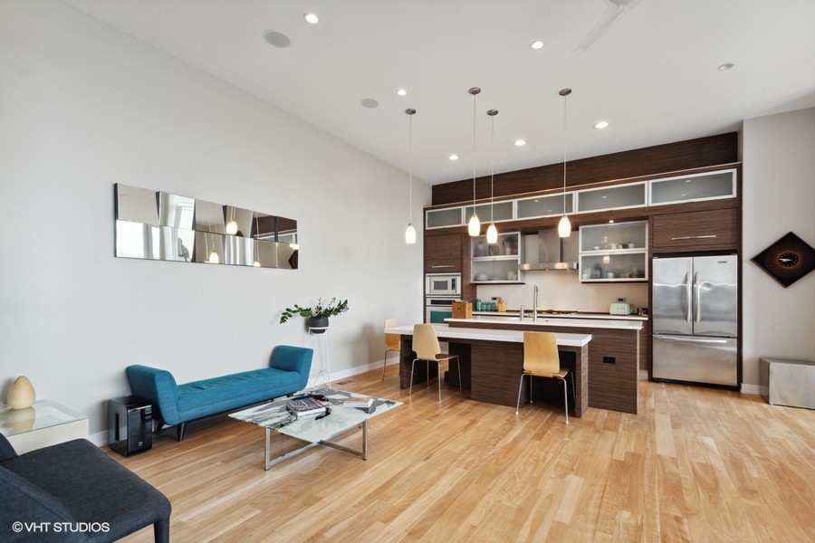 2408 West Rice Street, Unit 403 Chicago, IL 60622 - Photo 4 of 19 a living room with stainless steel appliances furniture a rug and a kitchen view