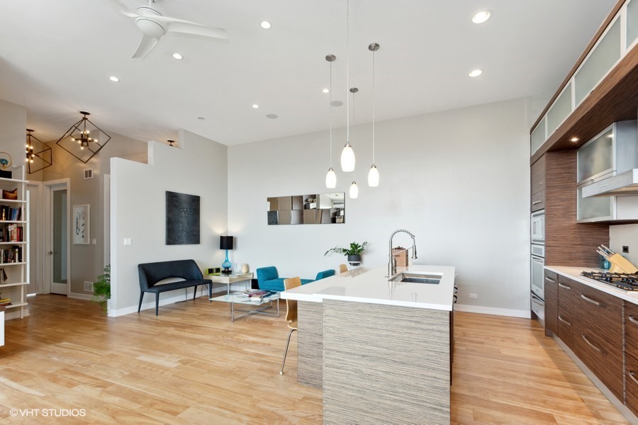 2408 West Rice Street, Unit 403 Chicago, IL 60622 - Photo 6 of 19 a living room with furniture kitchen view and a wooden floor