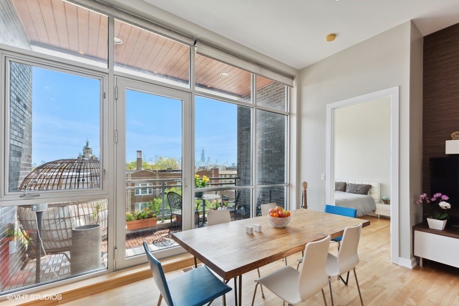 2408 West Rice Street, Unit 403 Chicago, IL 60622 - Photo 7 of 19 a view of a dining room with furniture window and wooden floor