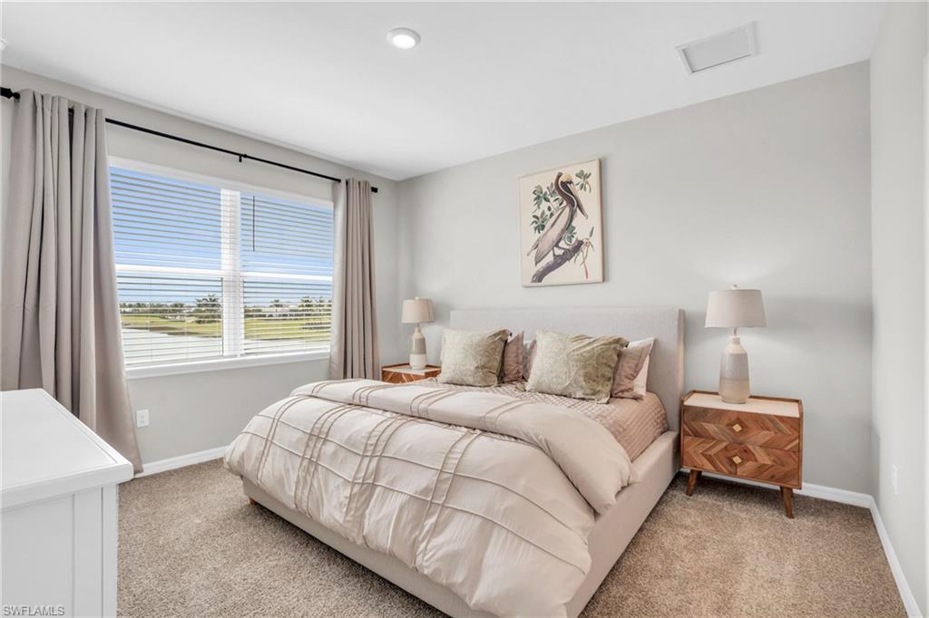 11761 Venetian Lagoon Drive, Unit 204 Fort Myers, FL 33913 - Photo 15 of 46 Bedroom featuring light carpet and baseboards