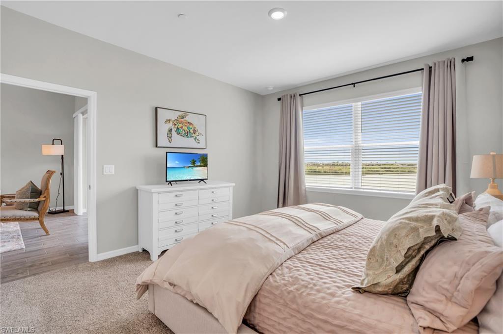 11761 Venetian Lagoon Drive, Unit 204 Fort Myers, FL 33913 - Photo 16 of 46 Bedroom featuring baseboards and light colored carpet