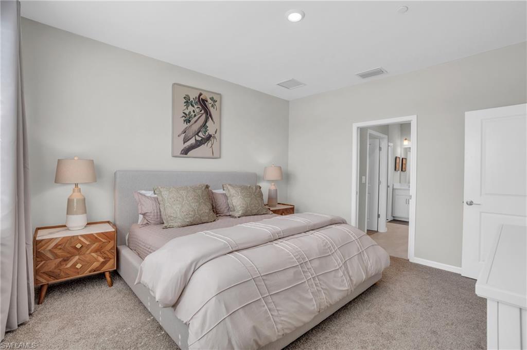 11761 Venetian Lagoon Drive, Unit 204 Fort Myers, FL 33913 - Photo 17 of 46 Carpeted bedroom with visible vents and baseboards