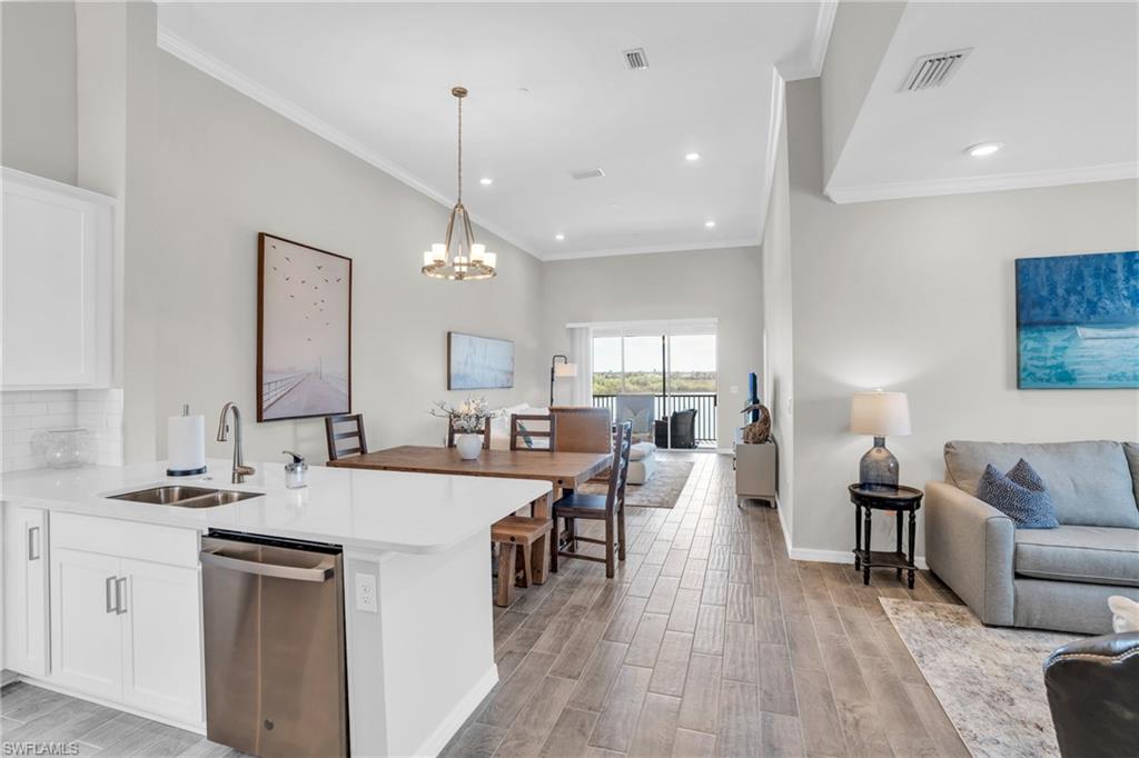 11761 Venetian Lagoon Drive, Unit 204 Fort Myers, FL 33913 - Photo 5 of 46 Kitchen featuring visible vents, a sink, open floor plan, dishwasher, and light wood-type flooring