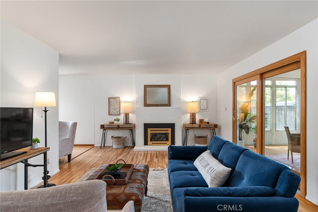 12 Amber Way Chico, CA 95926 - Photo 15 of 37 a living room with furniture a fireplace a flat screen tv and a large window