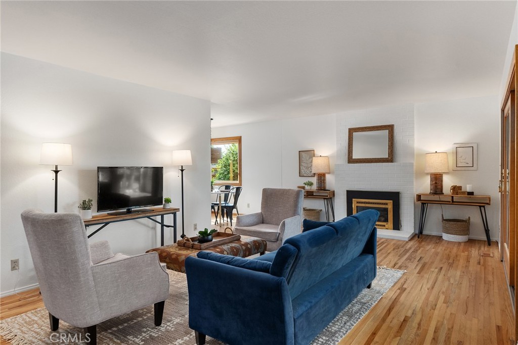 12 Amber Way Chico, CA 95926 - Photo 16 of 37 a living room with furniture a fireplace and a flat screen tv