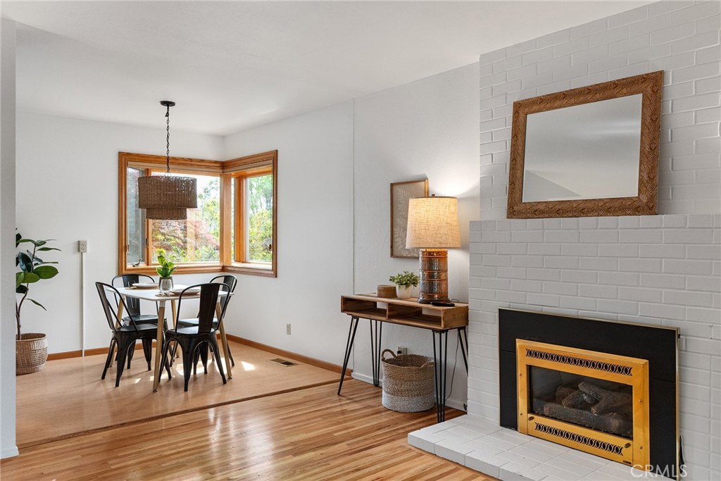 12 Amber Way Chico, CA 95926 - Photo 17 of 37 a dining room with furniture wooden floor a rug and a fireplace