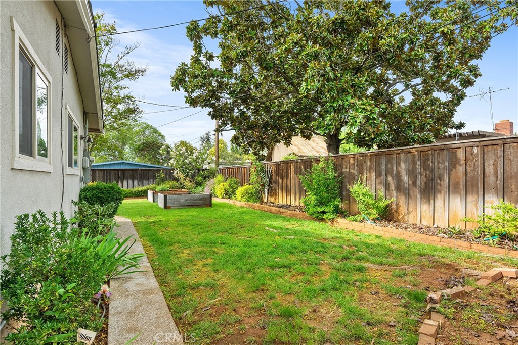 12 Amber Way Chico, CA 95926 - Photo 33 of 37 a view of backyard with table and chairs and wooden fence