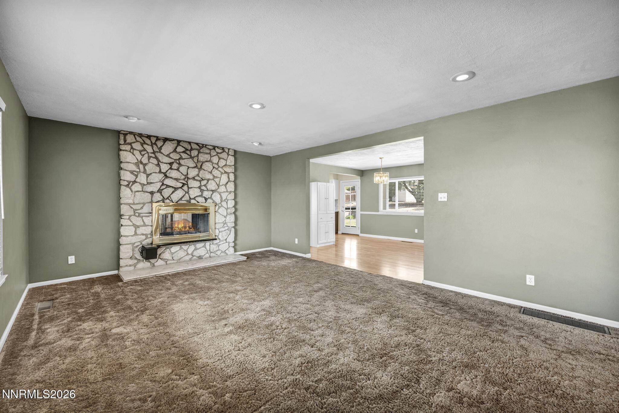 14190 Rim Rock Drive Reno, NV 89521 - Photo 9 of 68 a view of an empty room with a fireplace and a window