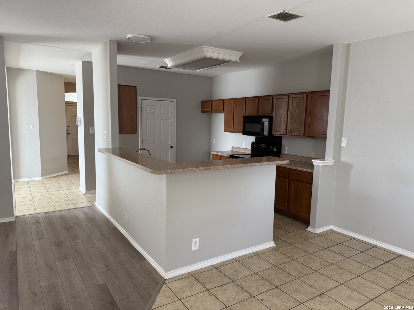 105 Eagle Flight Cibolo, TX 78108 - Photo 6 of 32 a kitchen with stainless steel appliances a sink a stove a microwave a refrigerator a cabinets and wooden floor