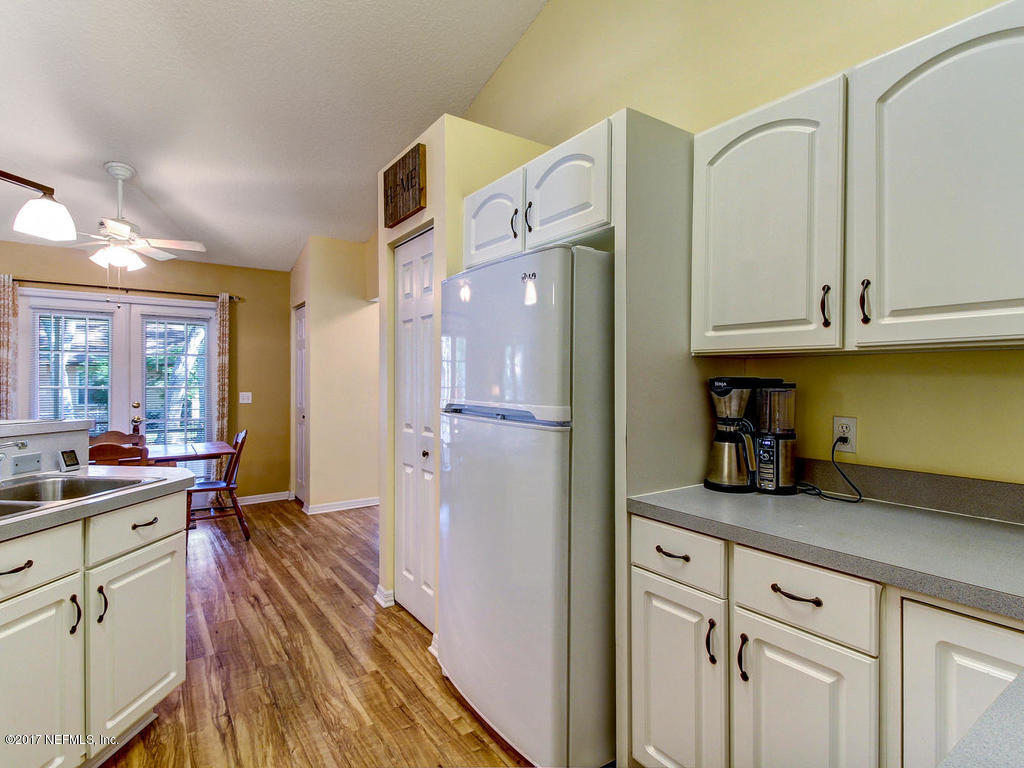 144 Tanager Road St. Augustine, FL 32086 - Photo 11 of 46 a kitchen with cabinets and a wooden floor