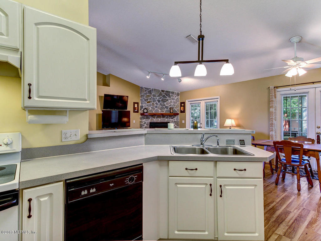144 Tanager Road St. Augustine, FL 32086 - Photo 12 of 46 a kitchen with kitchen island granite countertop a sink a counter space appliances and cabinets