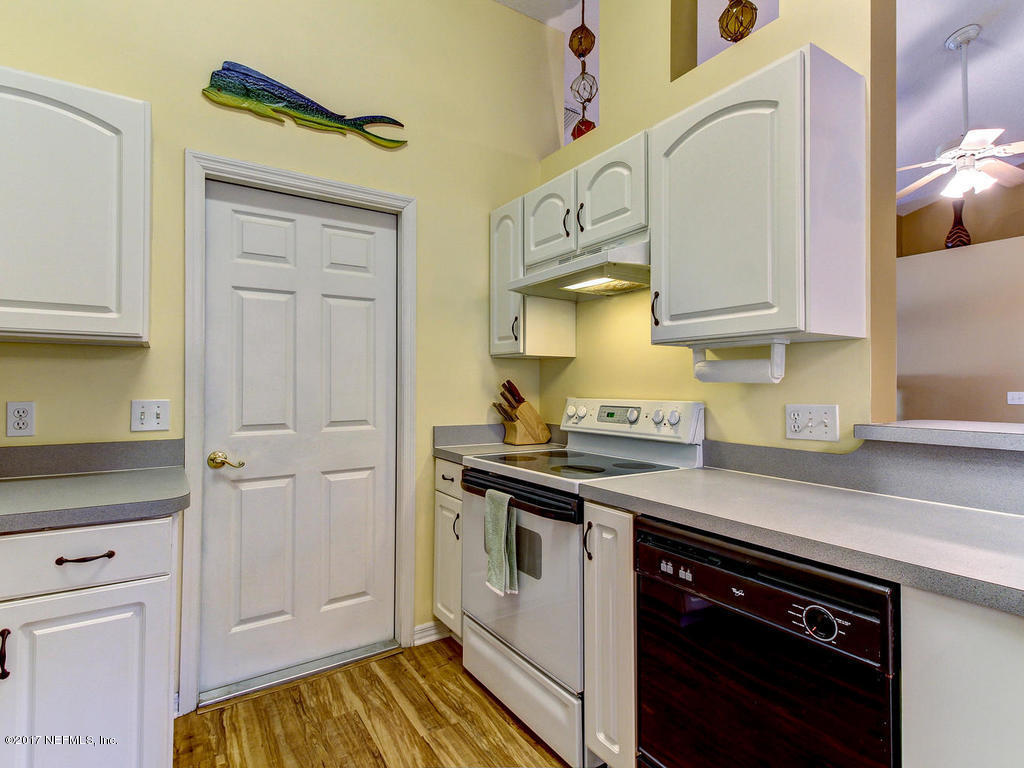 144 Tanager Road St. Augustine, FL 32086 - Photo 14 of 46 a kitchen with stainless steel appliances granite countertop a sink and cabinets