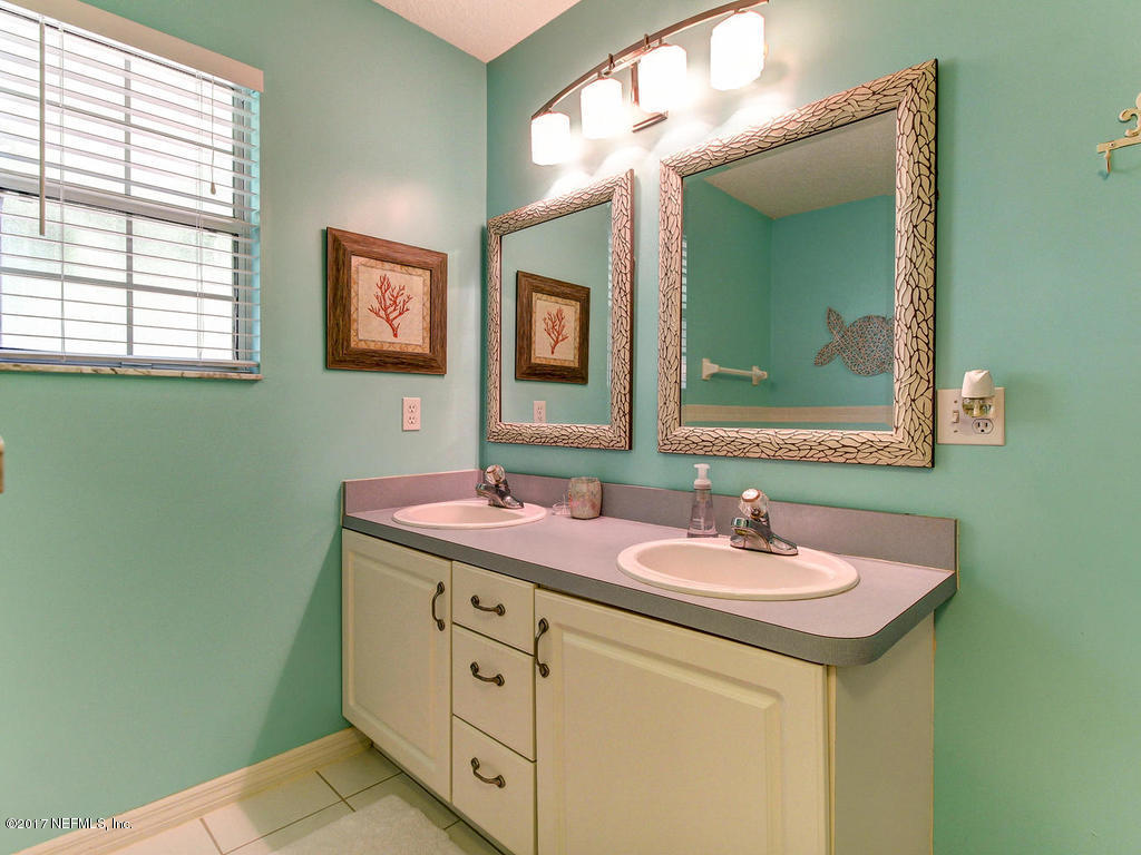 144 Tanager Road St. Augustine, FL 32086 - Photo 16 of 46 a bathroom with a double vanity sink and a mirror