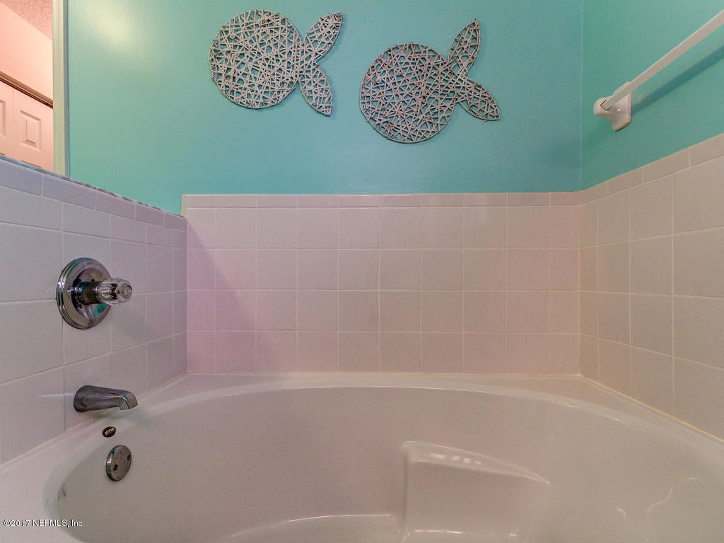 144 Tanager Road St. Augustine, FL 32086 - Photo 18 of 46 a bathroom with a bathtub and a shower