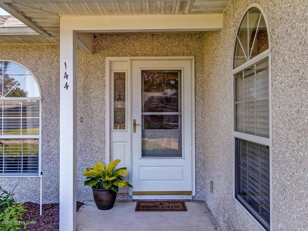 144 Tanager Road St. Augustine, FL 32086 - Photo 2 of 46 a front view of a house with a garden