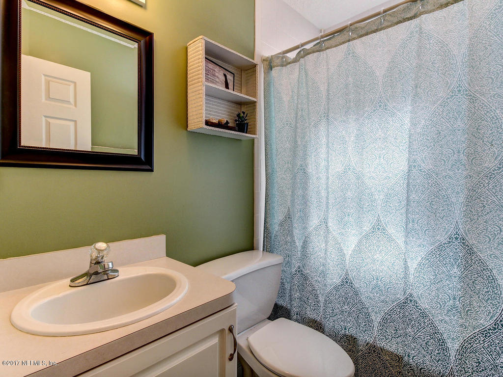 144 Tanager Road St. Augustine, FL 32086 - Photo 22 of 46 a bathroom with a sink a toilet and shower curtain