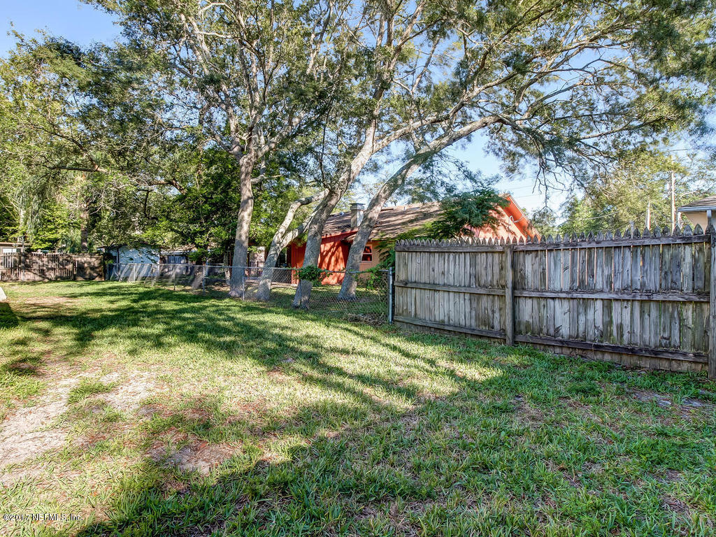 144 Tanager Road St. Augustine, FL 32086 - Photo 29 of 46 a view of a backyard with wooden fence and a large tree