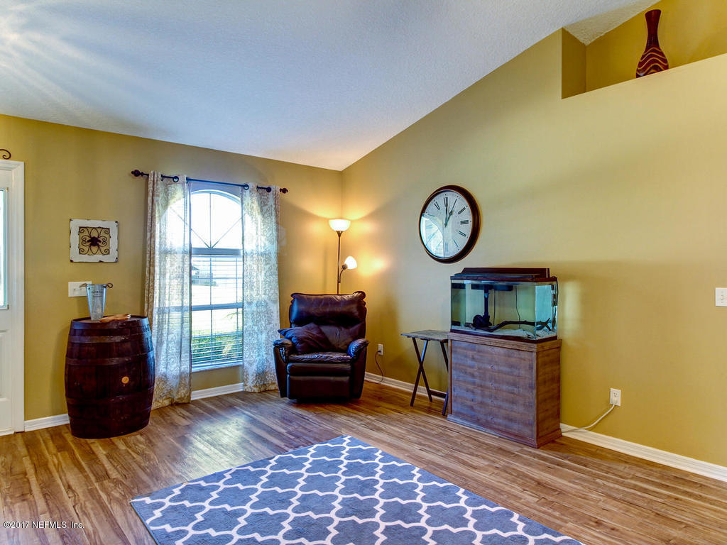144 Tanager Road St. Augustine, FL 32086 - Photo 6 of 46 a living room with furniture a rug and a window