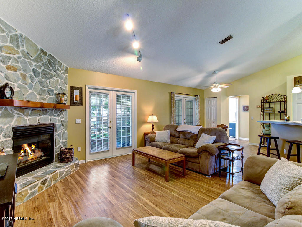 144 Tanager Road St. Augustine, FL 32086 - Photo 8 of 46 a living room with furniture and a fireplace