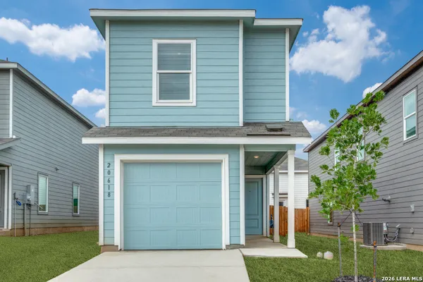 a front view of a house with a yard and garage