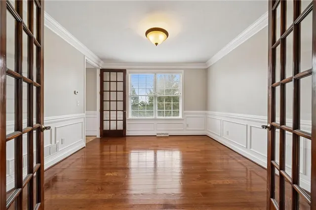 a view of large kitchen with stainless steel appliances kitchen island a stove a refrigerator cabinets and living room view