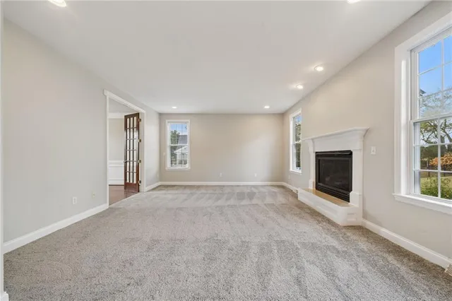 wooden floor in an empty room with a ceiling fan