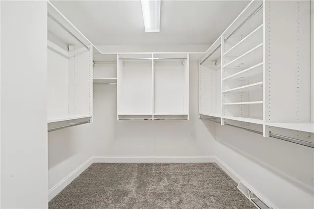 a bathroom with a granite countertop sink a toilet and a mirror