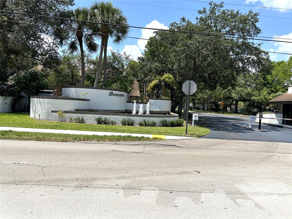 7680 Northwest 79th Avenue, Unit P1 Tamarac, FL 33321 - Photo 1 of 28 a view of a tennis ground with large trees