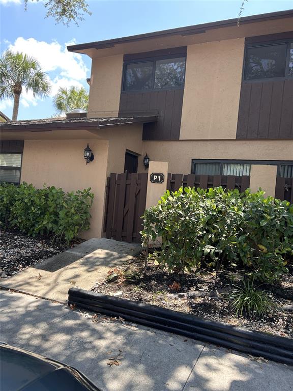 7680 Northwest 79th Avenue, Unit P1 Tamarac, FL 33321 - Photo 2 of 28 a view of a yard with potted plants