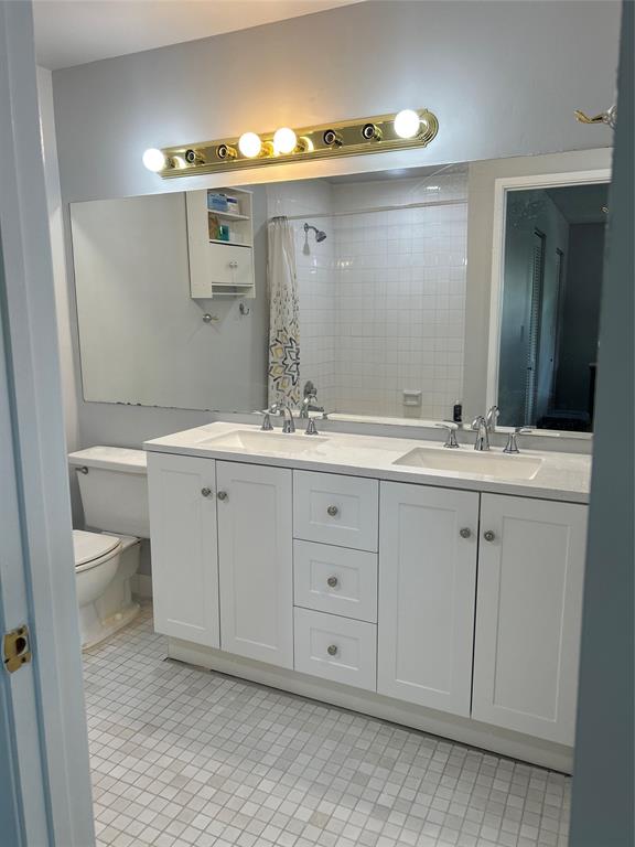 7680 Northwest 79th Avenue, Unit P1 Tamarac, FL 33321 - Photo 21 of 28 a bathroom with a granite countertop sink and a mirror