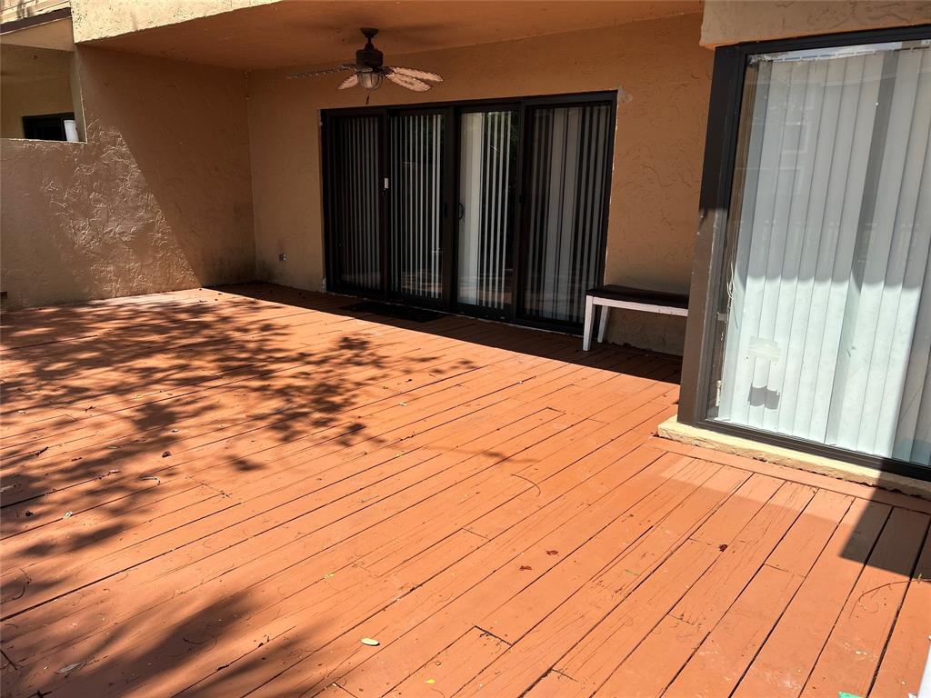7680 Northwest 79th Avenue, Unit P1 Tamarac, FL 33321 - Photo 25 of 28 a bedroom with a bed and wooden floor