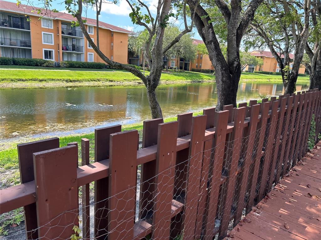 7680 Northwest 79th Avenue, Unit P1 Tamarac, FL 33321 - Photo 27 of 28 a view of a lake with a house next to a lake