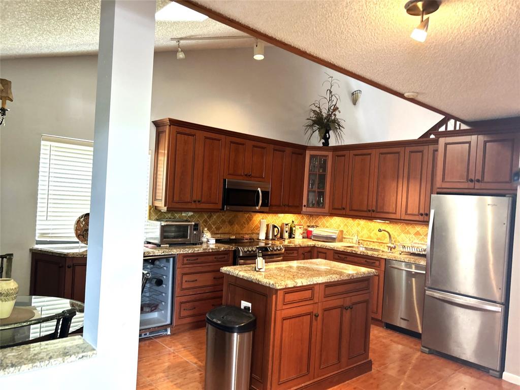 7680 Northwest 79th Avenue, Unit P1 Tamarac, FL 33321 - Photo 5 of 28 a kitchen with a sink refrigerator and microwave