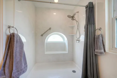 a bathroom with a glass shower door