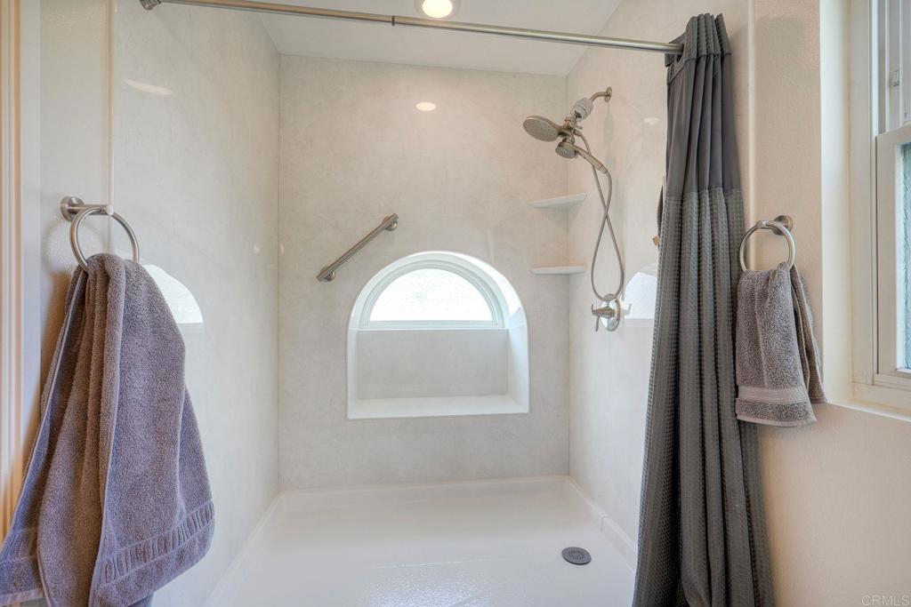 13639 Freeport Road San Diego, CA 92129 - Photo 24 of 44 a bathroom with a glass shower door