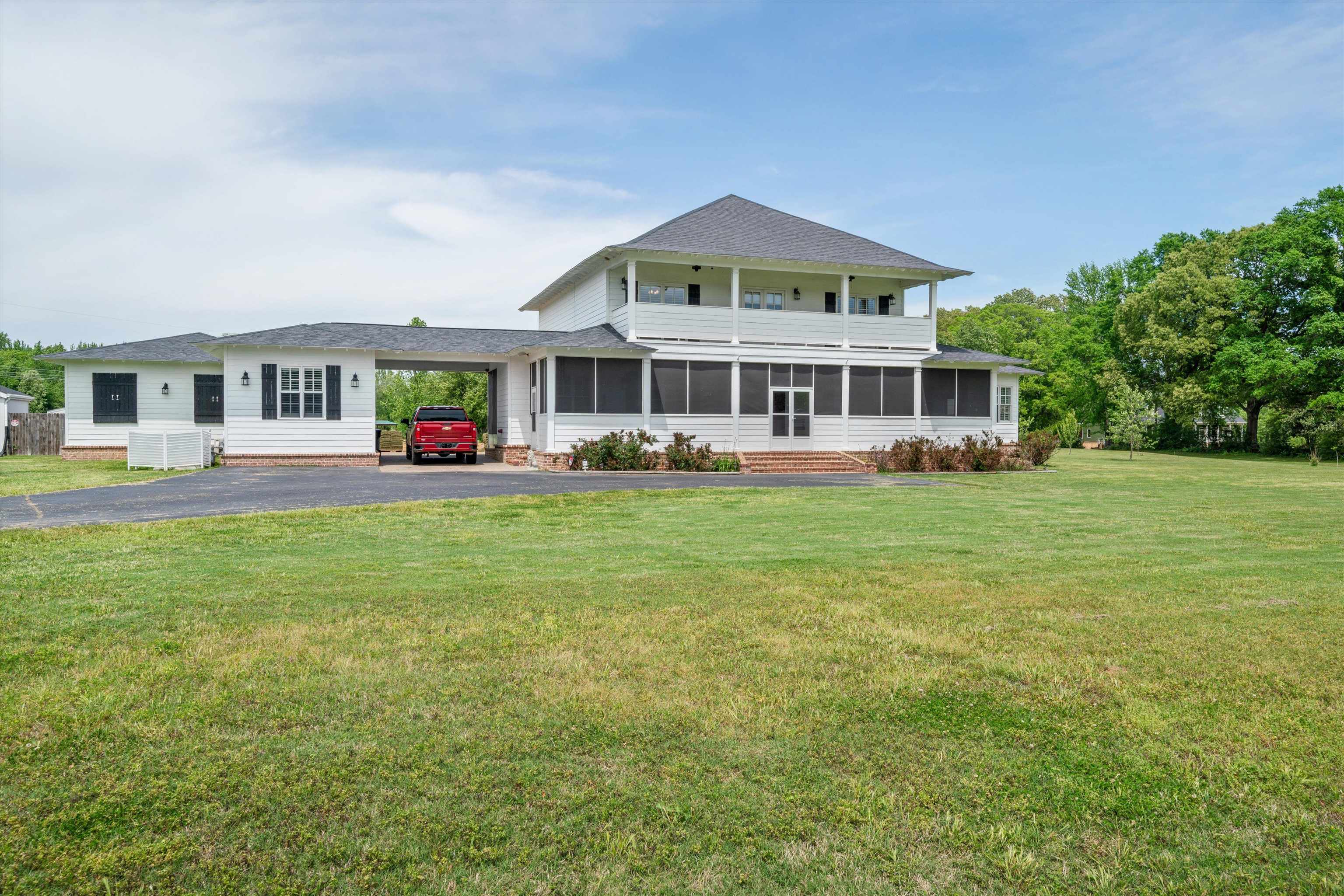 11300 Long Road Arlington, TN 38002 - Photo 1 of 39 a front view of a house with a garden and trees
