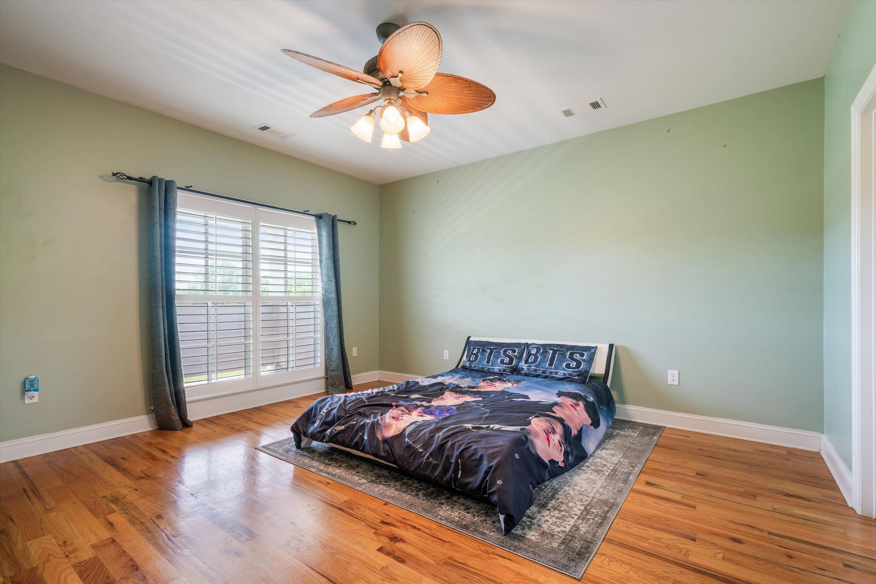 11300 Long Road Arlington, TN 38002 - Photo 19 of 39 a bedroom with a large bed and a chandelier
