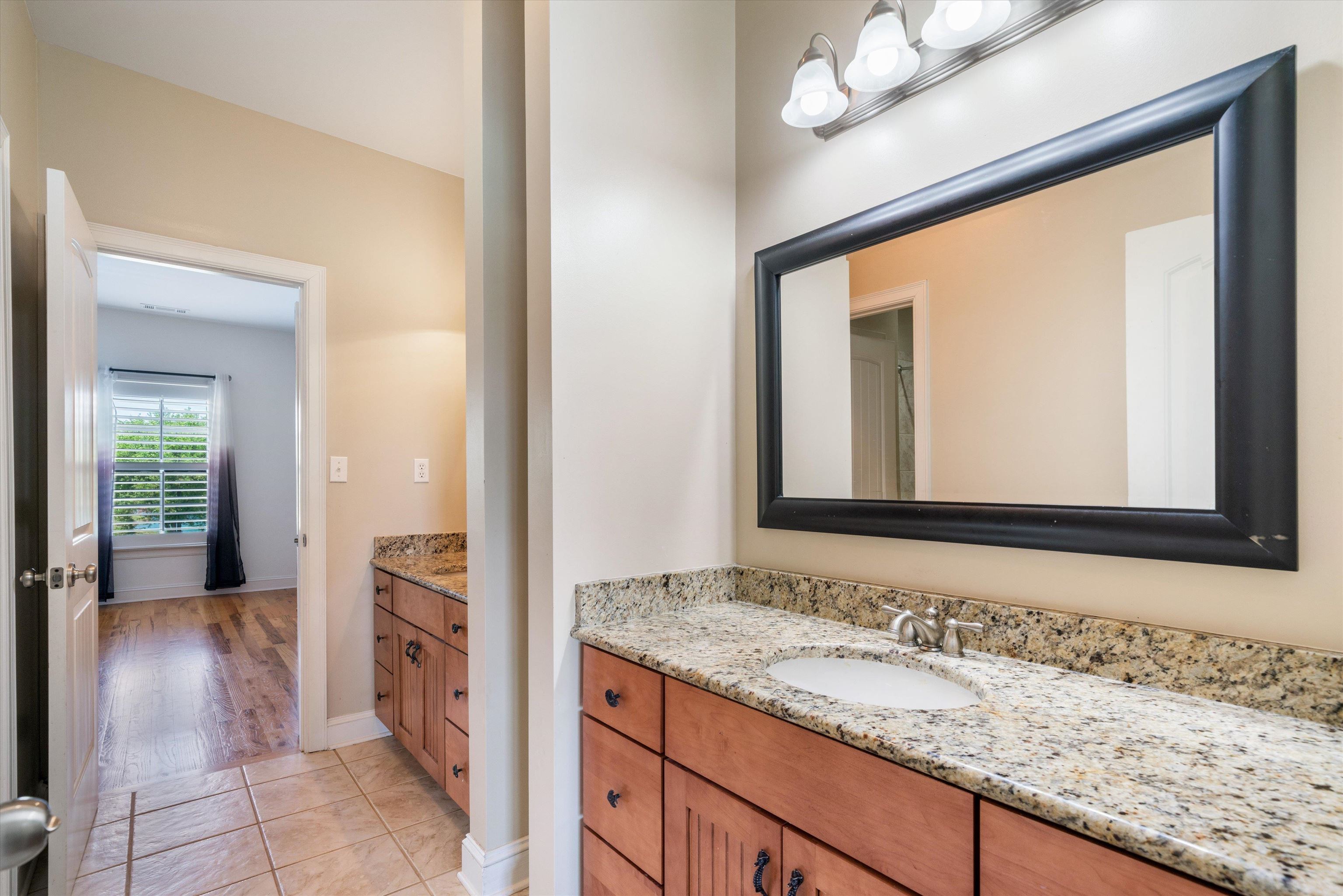 11300 Long Road Arlington, TN 38002 - Photo 21 of 39 a bathroom with a granite countertop sink and a mirror
