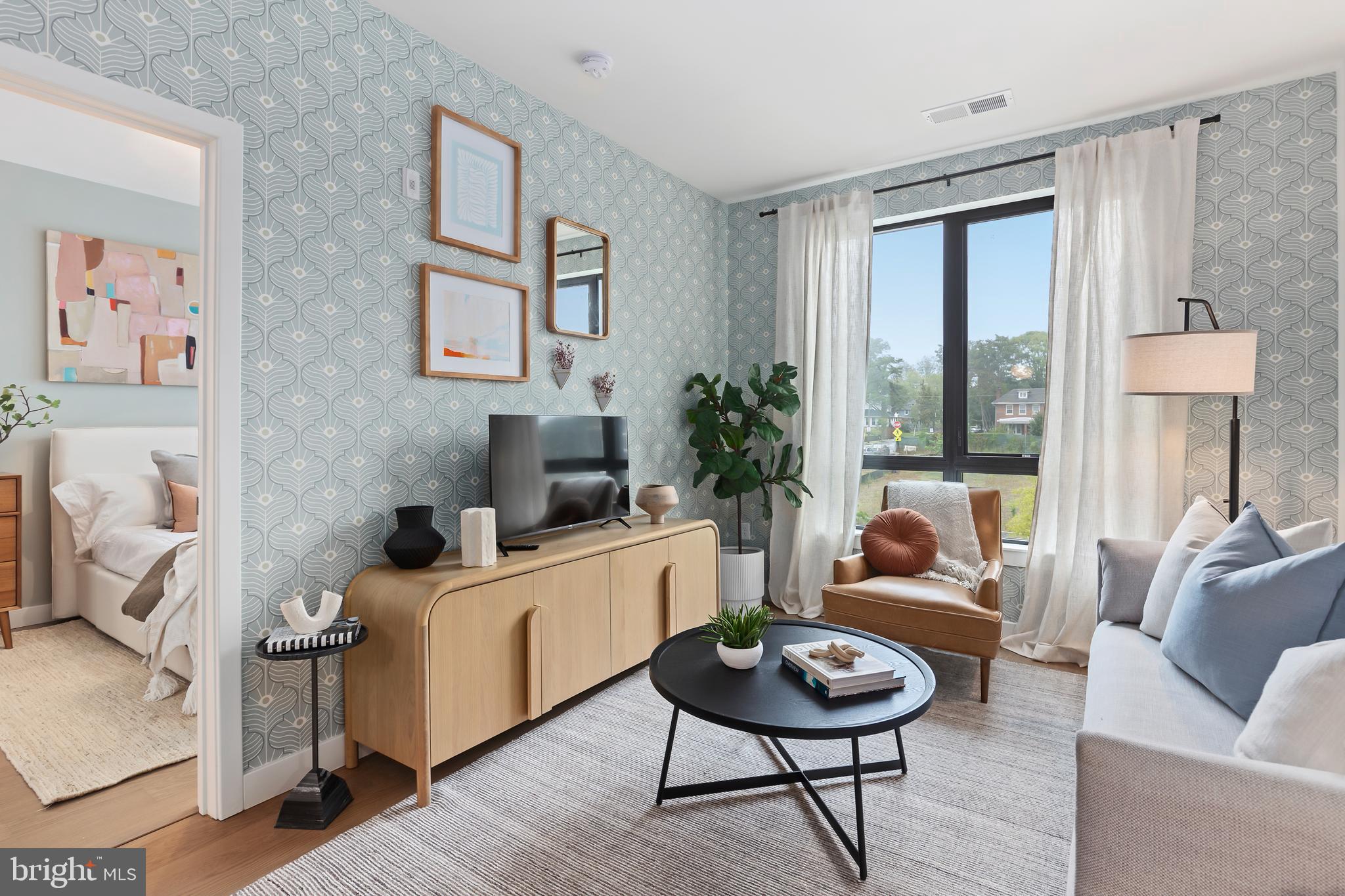 7175 12th Street Northwest, Unit 411 Washington, DC 20012 - Photo 14 of 46 a living room with furniture and a large window
