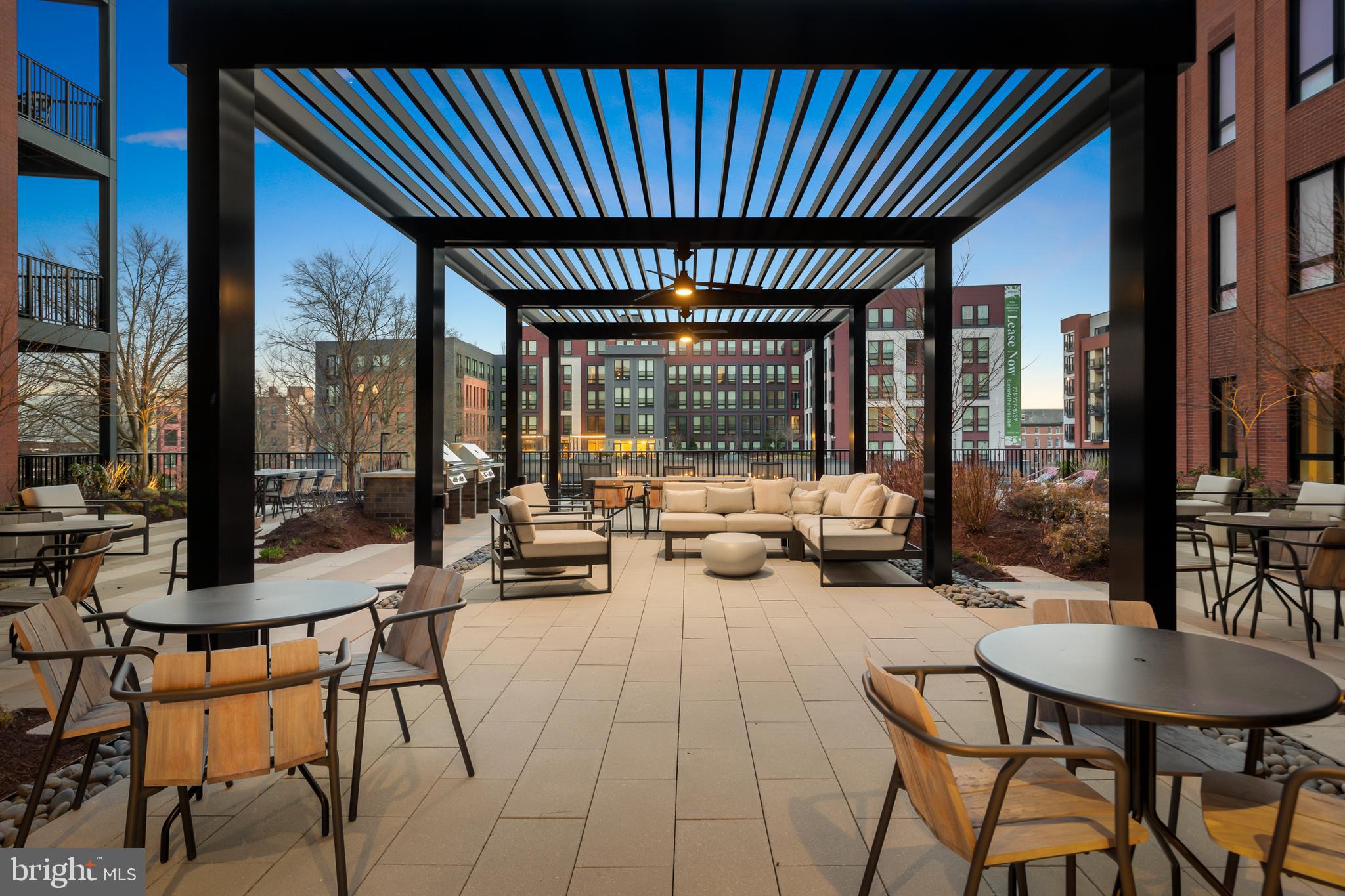7175 12th Street Northwest, Unit 411 Washington, DC 20012 - Photo 26 of 46 a patio with patio table and chairs