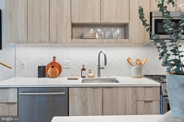 a kitchen with a sink a stove and cabinets