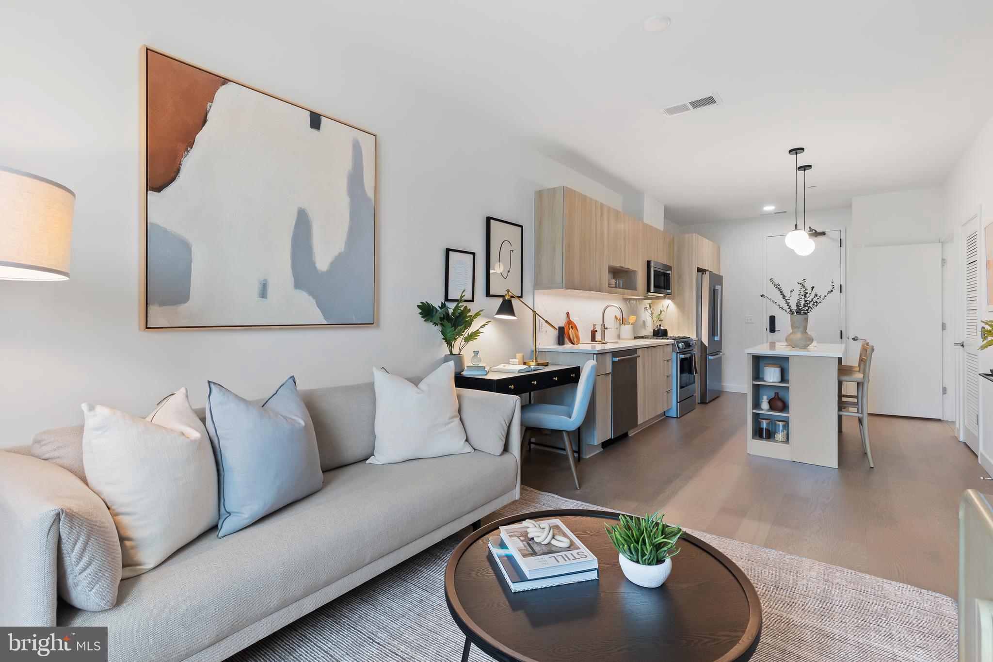 7175 12th Street Northwest, Unit 411 Washington, DC 20012 - Photo 10 of 46 a living room with furniture and a table