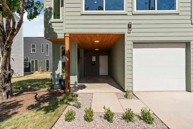 a kitchen with stainless steel appliances kitchen island a stove a sink a microwave a refrigerator and cabinets