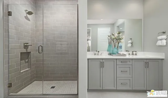 a bathroom with a shower sink and mirror