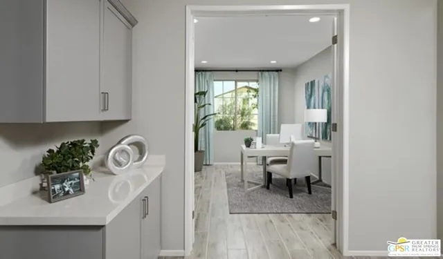 a living room with furniture a window and potted plants