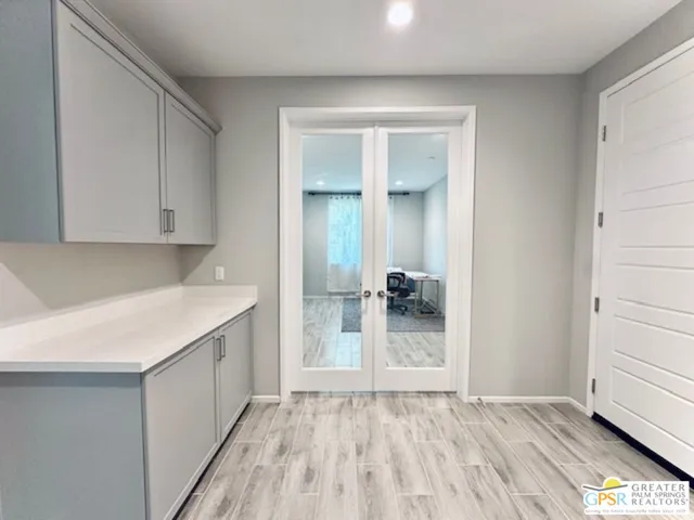 a view of a kitchen with wooden floor and a sink
