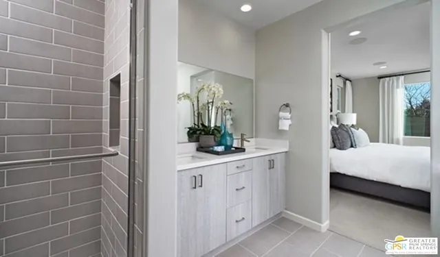 a bathroom with a sink a potted plant and a mirror